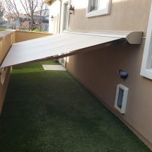 This dog run is protected with a retractable awning in Rocklin, CA